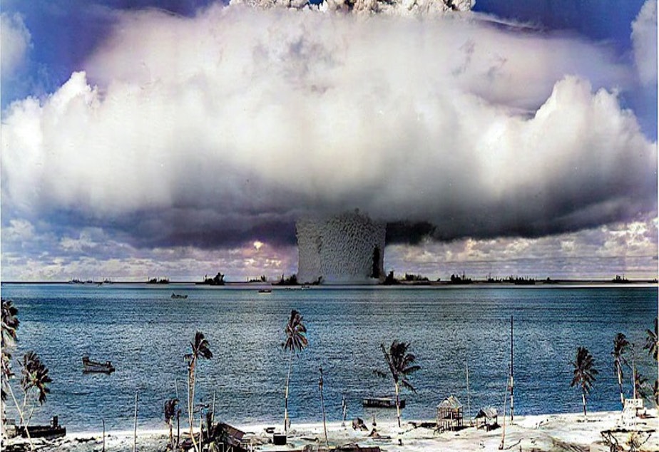 caption: The Baker explosion, one of many nuclear bombs the US detonated at the Marshall Islands.