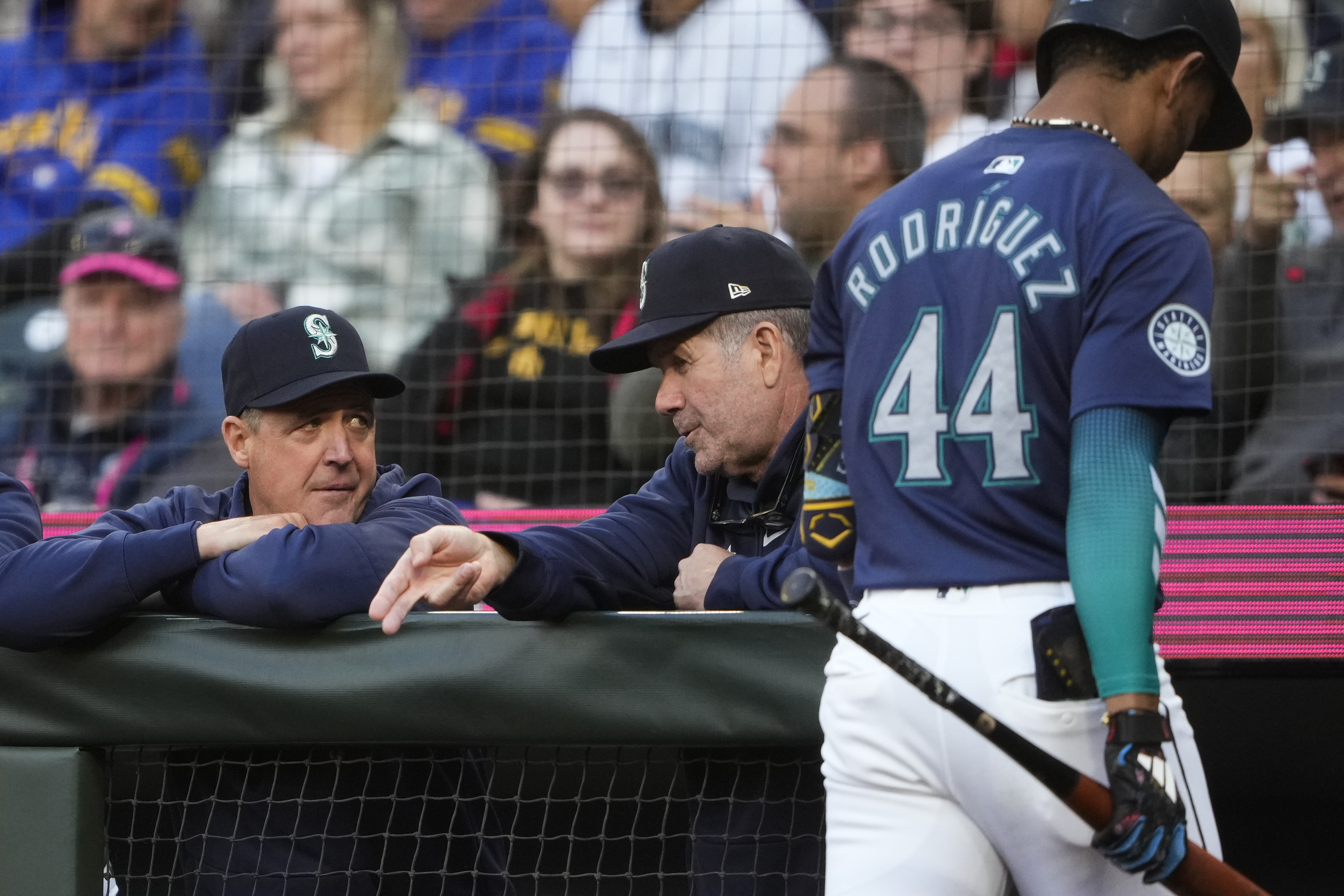 caption: Seattle Mariners manager Dan Wilson, left, talks with hitting coach Edgar Martinez as Julio Rodríguez (44) walks to the dugout after striking out against the Tampa Bay Rays during the first inning of a baseball game, Tuesday, Aug. 27, 2024, in Seattle.