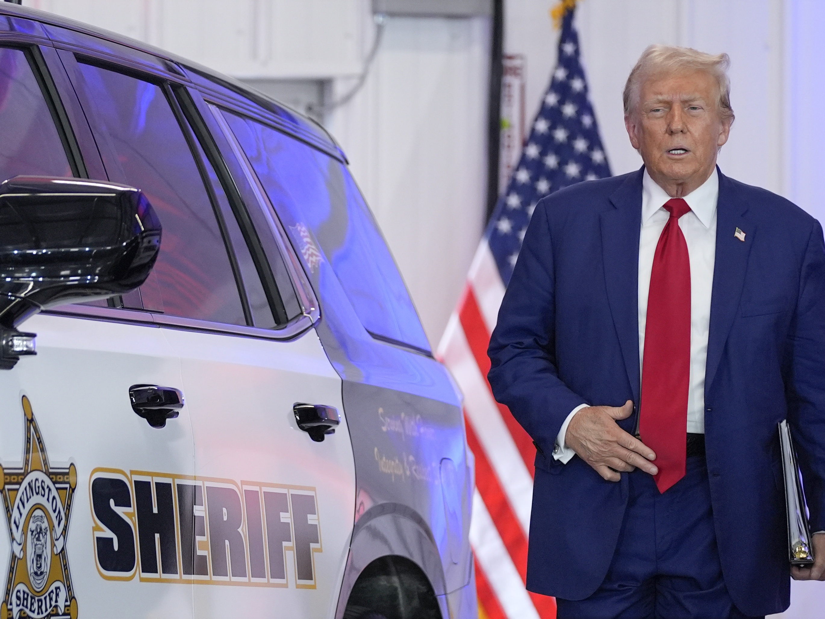 caption: President Donald Trump arrives to speak on crime and safety during a campaign event at the Livingston County Sheriff's Office Aug. 20, 2024, in Howell, Mich. (AP Photo/Evan Vucci)