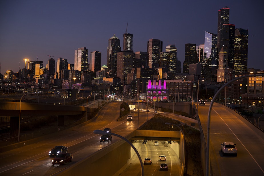 caption: Cars drive into the southern entrance of the SR 99 tunnel as the sun sets on Wednesday, October 9, 2019, in Seattle. 