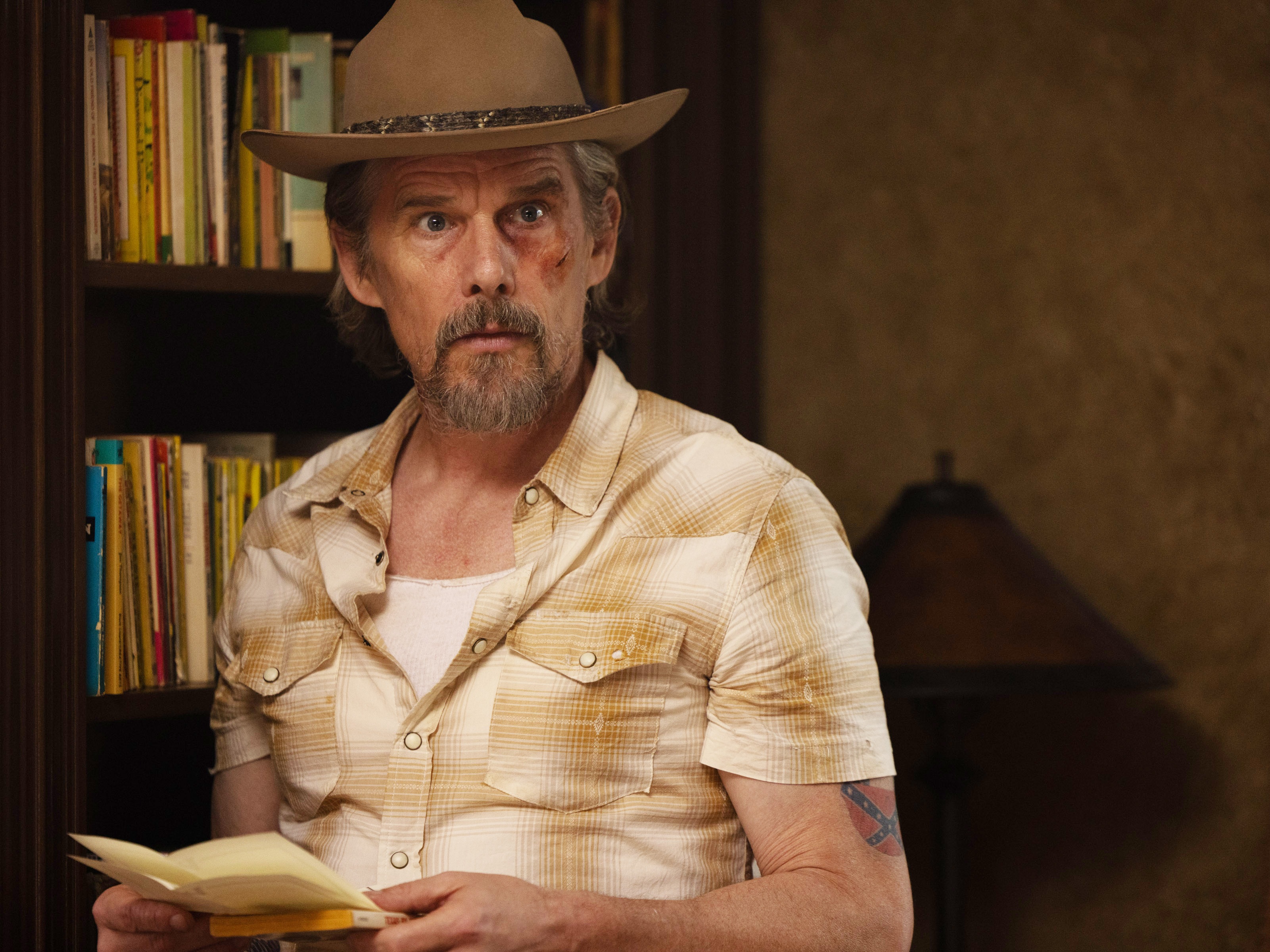 caption: Ethan Hawke plays a used bookstore owner who moonlights as a muckraking reporter in <em>The Lowdown.</em>