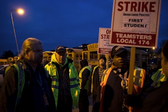 caption: School bus drivers with Teamsters Local 174 strike on Thursday, Feb. 1, 2018, outside of the First Student bus lot on Lake City Way Northeast in Seattle.