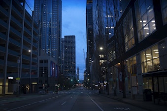 caption: A quieter than usual downtown Seattle is shown on Sunday, March 22, 2020, at the intersection of 2nd Avenue and Union Street in Seattle.