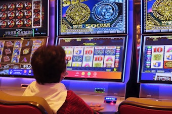 caption: A gambler plays a slot machine at the Hard Rock casino in Atlantic City, N.J. on Aug. 8, 2022.