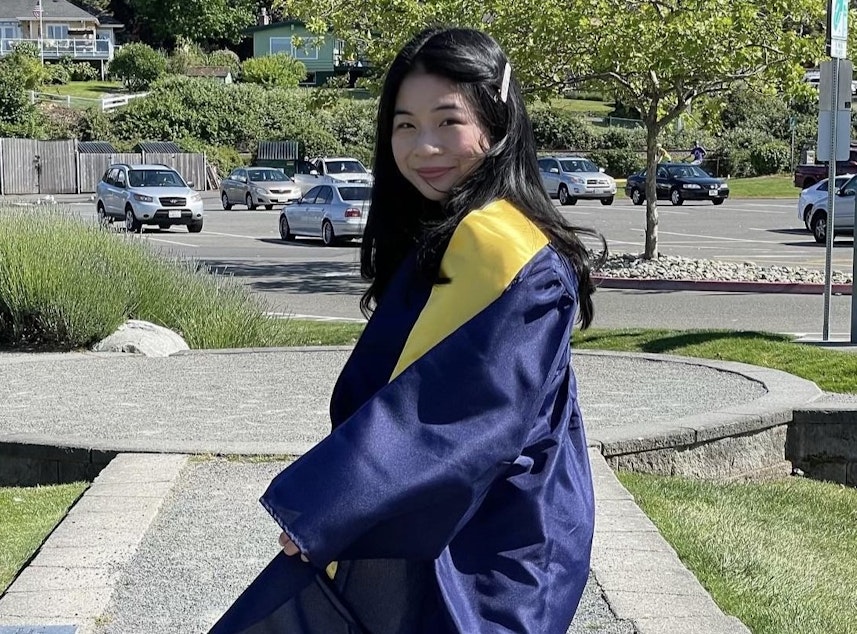 caption: Khanh Doan poses in their Mariner High School graduation gown in June 2021.