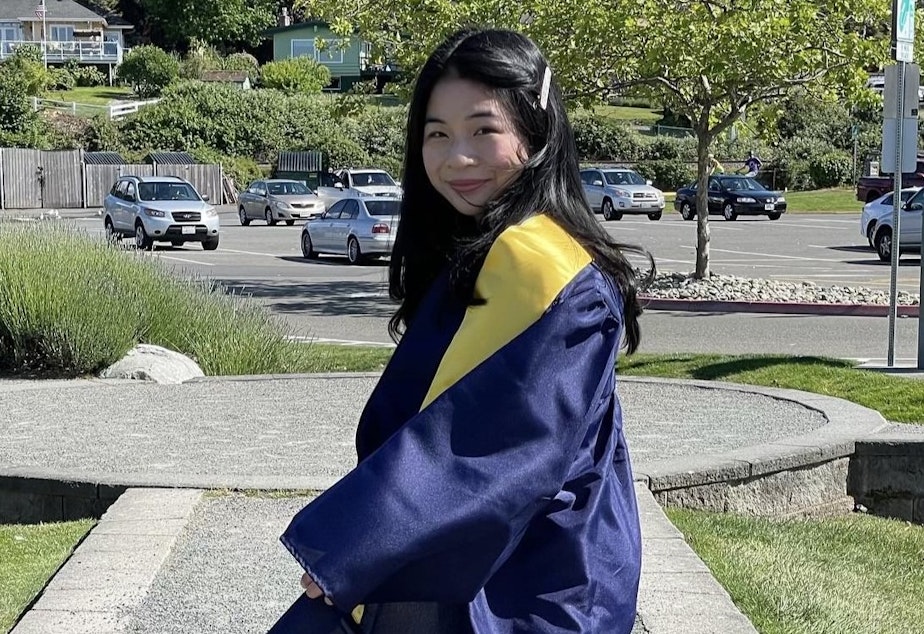 caption: Khanh Doan poses in their Mariner High School graduation gown in June 2021.