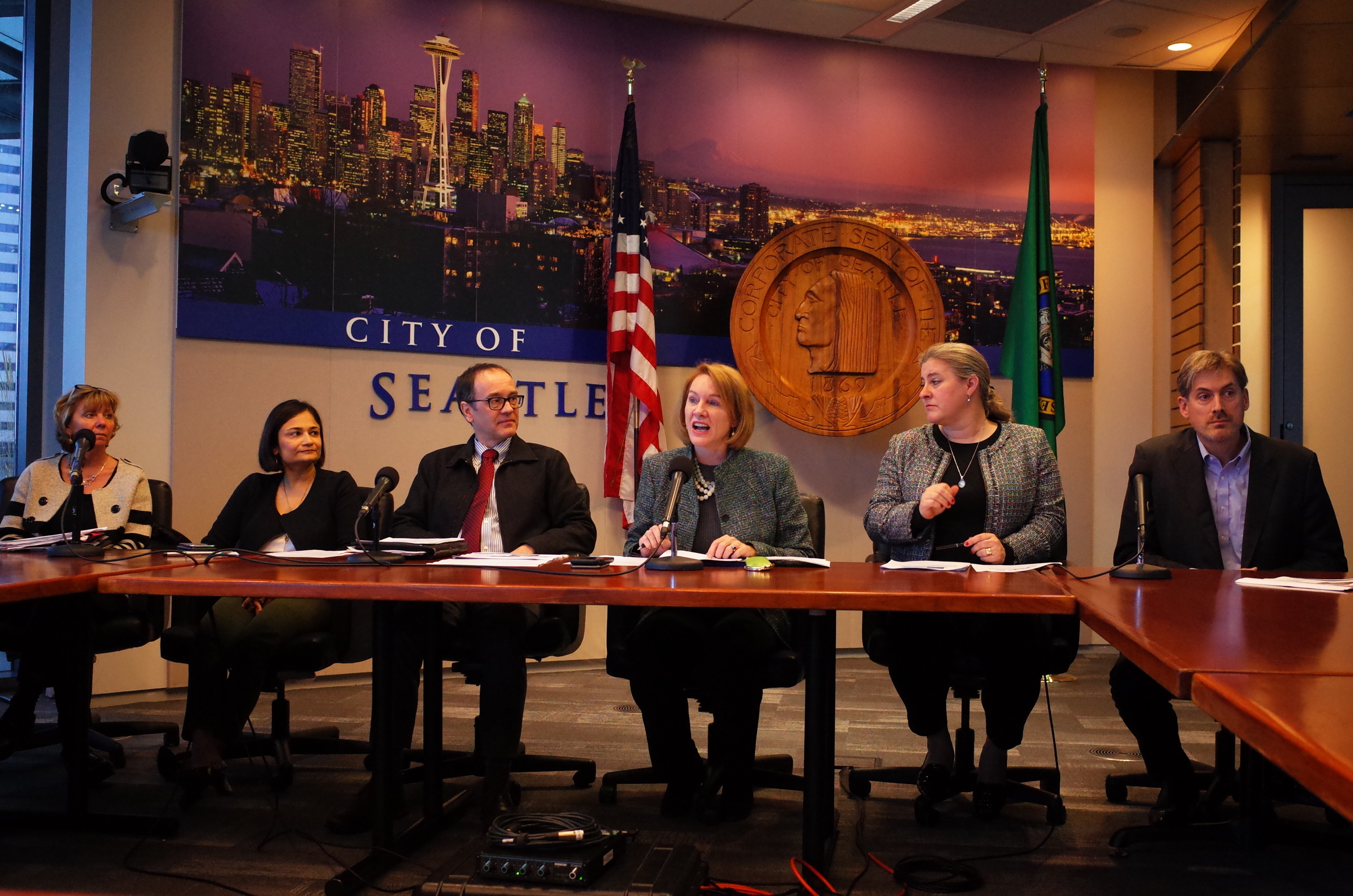 caption: Seattle Mayor Jenny Durkan and city, state and transit officials briefing reporters on December 20, 2018