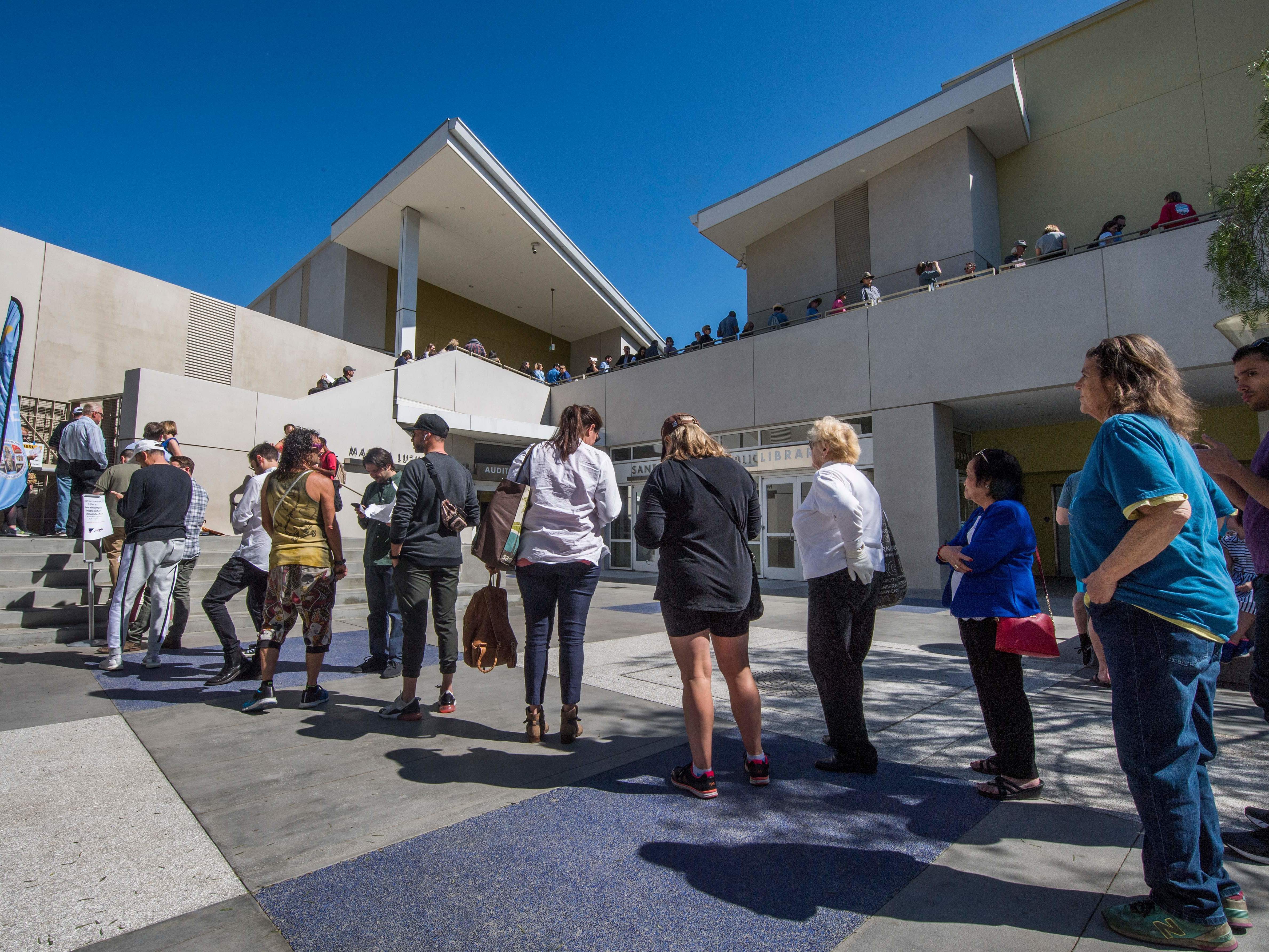 caption: People wait to vote during the presidential primary at the Santa Monica Public Library in Santa Monica, Calif. on Super Tuesday, March 3.