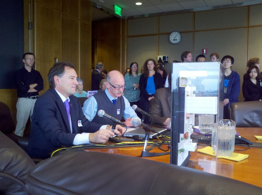 caption: Peter Steinbrueck and Cory Crocker show model of proposed plaza to UW Board of Regents. 