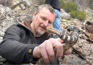 caption: Chris holding a Northern Pacific rattlesnake. The age of a snake can be determined by the number of coils on their rattlers.