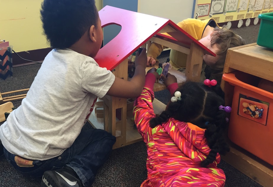 caption: Archival photo: Preschoolers play with a dollhouse at Launch at Leschi Elementary School, one of Seattle Preschool Program's first sites, in this archival photo from 2016.