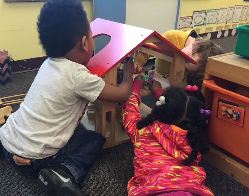 caption: Archival photo: Preschoolers play with a dollhouse at Launch at Leschi Elementary School, one of Seattle Preschool Program's first sites, in this archival photo from 2016.