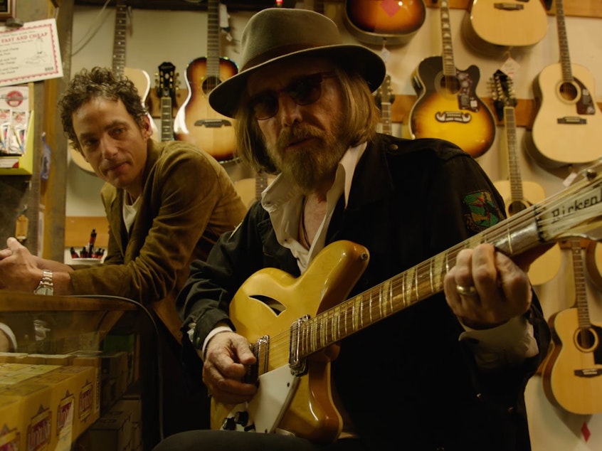 caption: Jakob Dylan (left) and Tom Petty in a still from <em>Echo in the Canyon</em>.