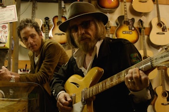 caption: Jakob Dylan (left) and Tom Petty in a still from <em>Echo in the Canyon</em>.