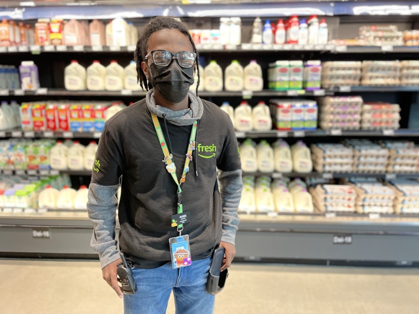 caption: Robel Teshome works at Amazon Fresh in Seattle's Central Area neighborhood. He lives nearby, and walks to work.