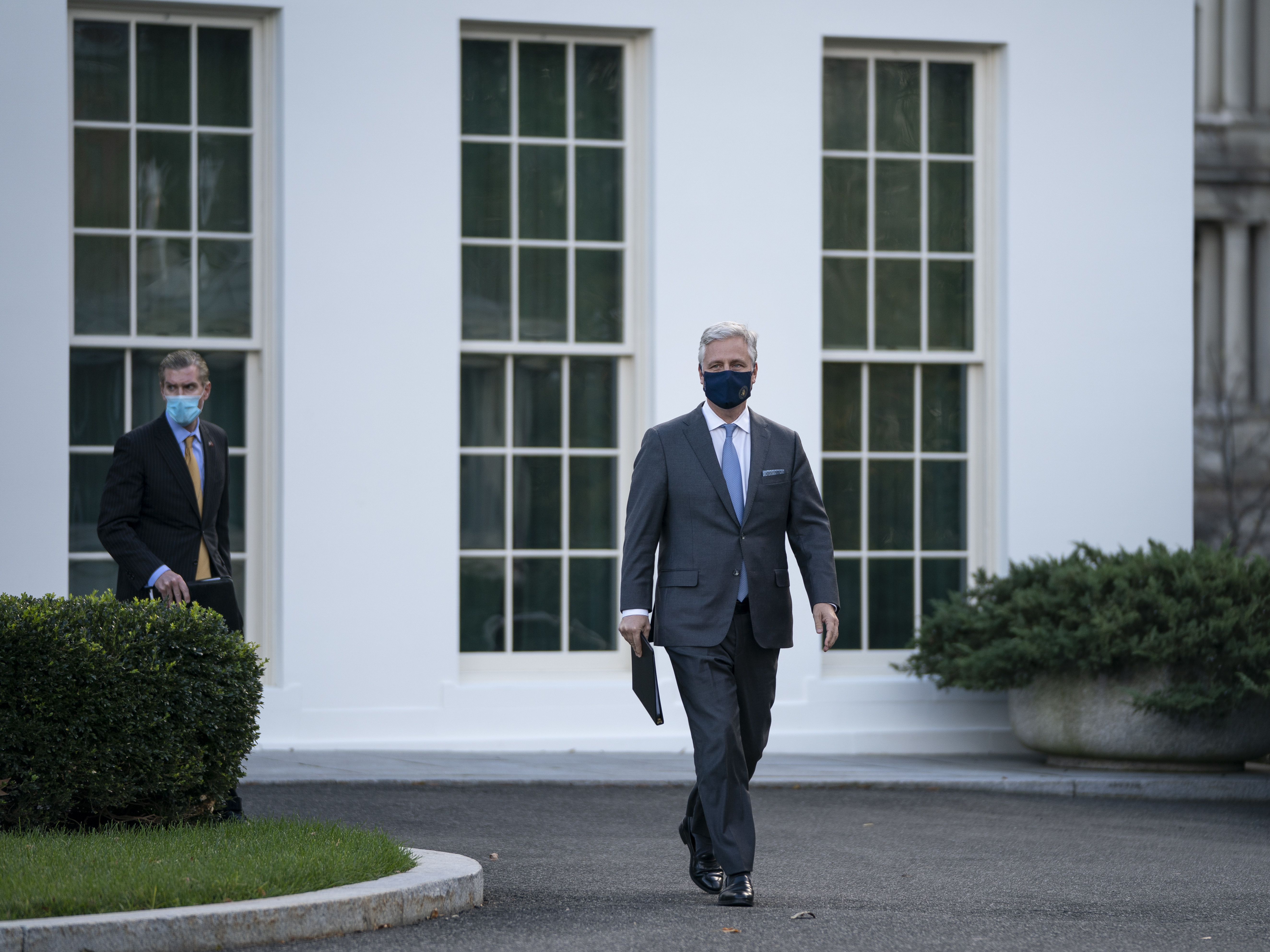 caption: National security adviser Robert O'Brien arrives to speak to reporters outside the White House on Tuesday. O'Brien announced that President Trump has ordered 2500 U.S. troops to be withdrawn from Afghanistan and Iraq by Jan. 15.