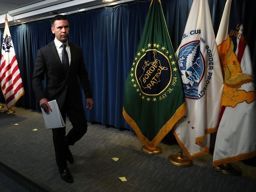 caption: Acting Secretary of Homeland Security Kevin McAleenan holds a news conference in June.