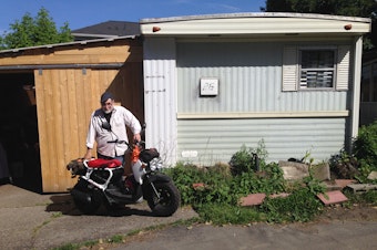 caption: Dave Martin stands outside his home in a trailer park on Lake City Way.