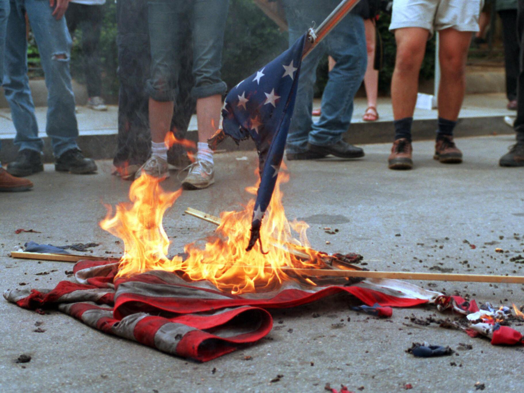 caption: A 2002 file photo shows demonstrators burning U.S. flags during a protest in front of the World Bank headquarters in Washington, D.C.
