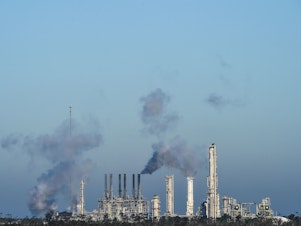 caption: An oil and gas processing plant  in Lake Charles, La. in October 2020. The Biden administration is expected to announce aggressive new targets for reducing greenhouse gas emissions.