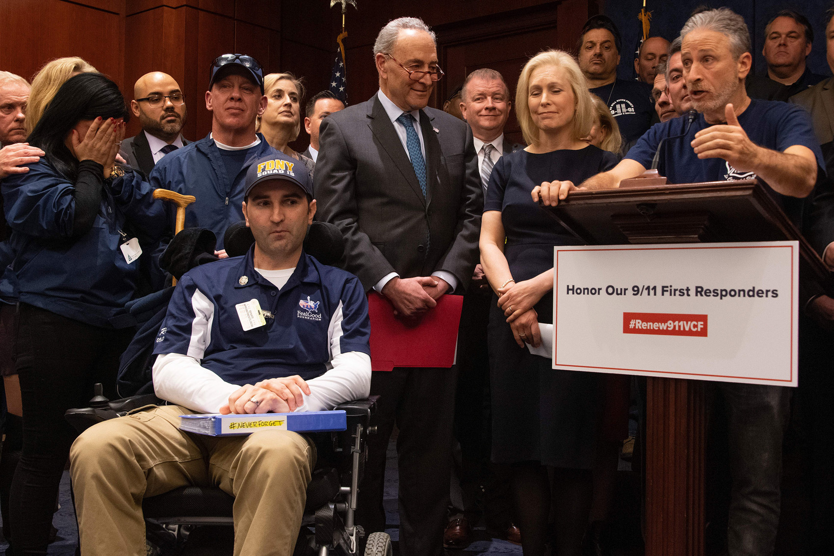 caption: Former "Daily Show" host Jon Stewart (right) with Senate Minority Leader Chuck Schumer (center), D-N.Y., Sen. Kirsten Gillibrand (second right), D-N.Y., and 9/11 first responders, survivors and their families to discuss the introduction of the bipartisan "Never Forget the Heroes: Permanent Authorization of the September 11th Victim Compensation Fund Act." (Jim Watson/AFP/Getty Images)