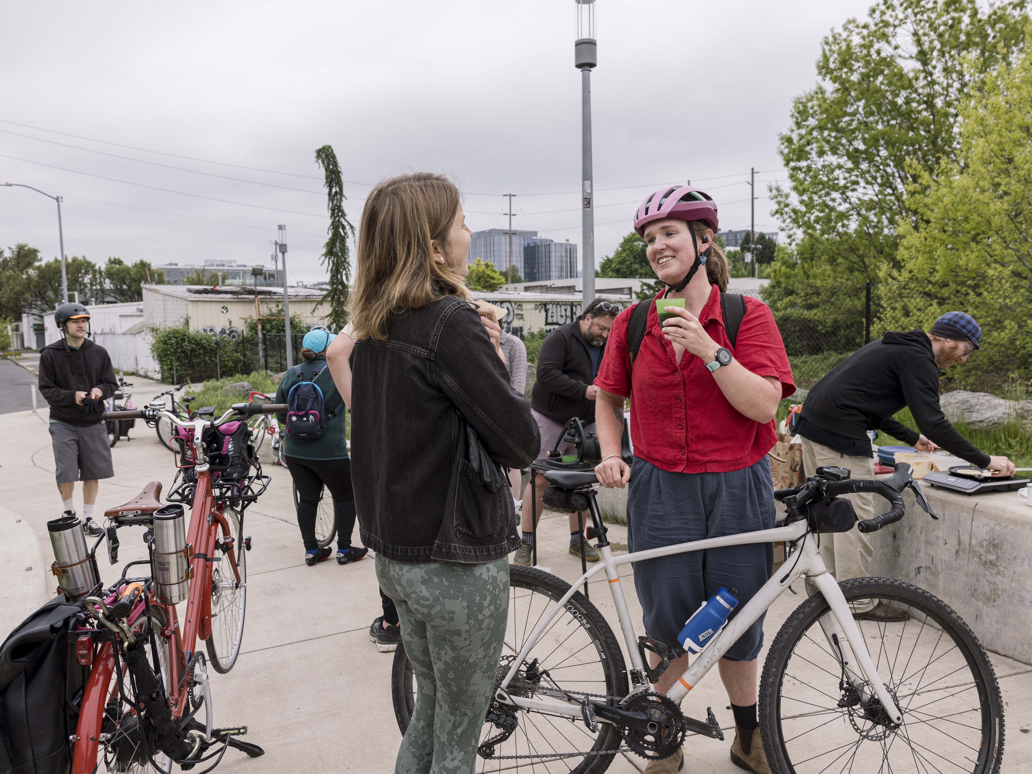 caption: Bicycle commuters stop to grab a cup of coffee and a chat on their way into work as part of Portland's "Breakfast on the Bridges."
