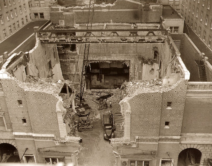 caption: The Metropolitan Theatre during demolition in 1956. The site is now a drop-off area for the Fairmont Hotel.