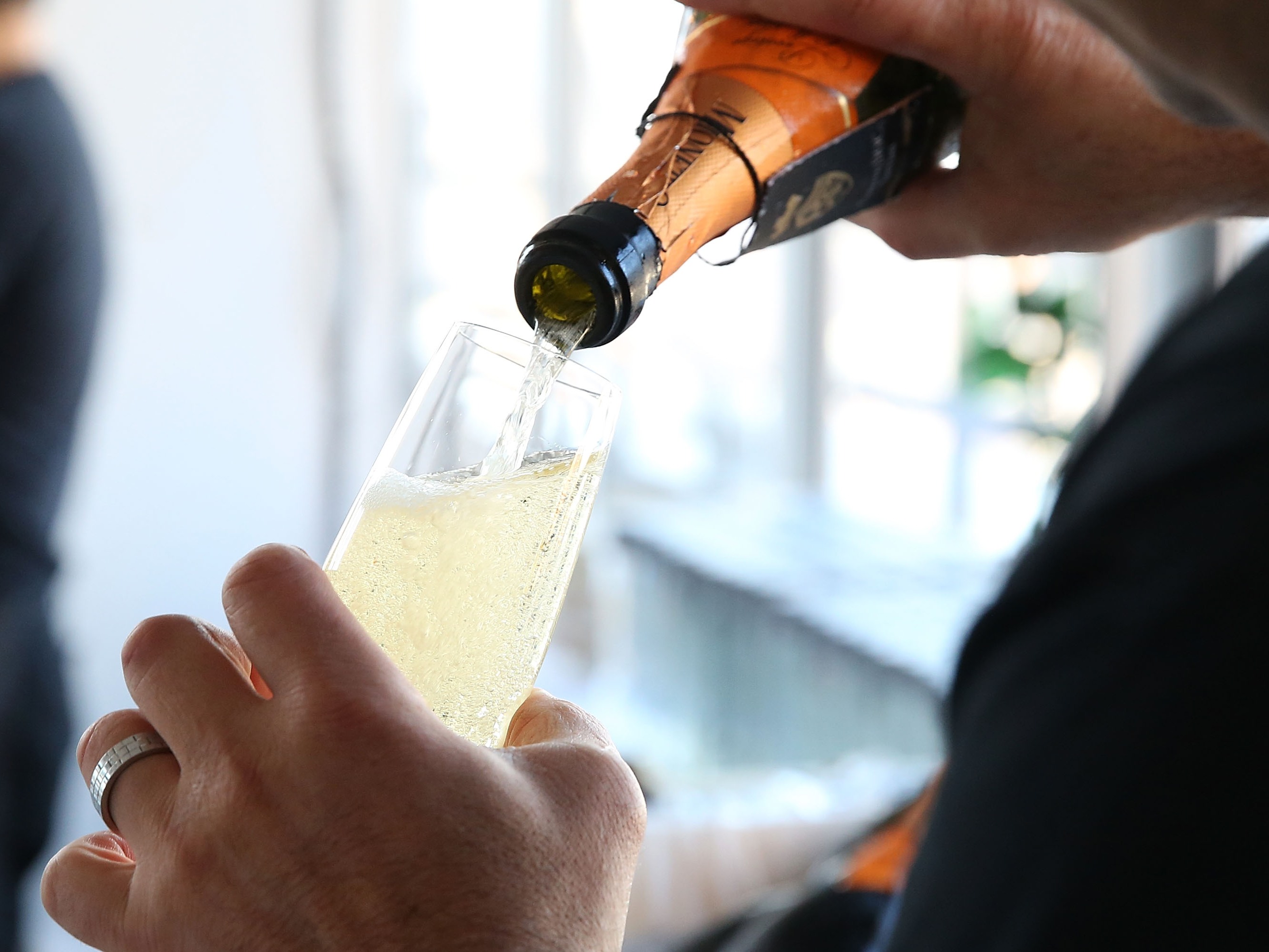 caption: A bartender pours Prosecco at Founder's Welcome Breakfast during Food Network New York City Wine &amp; Food Festival.