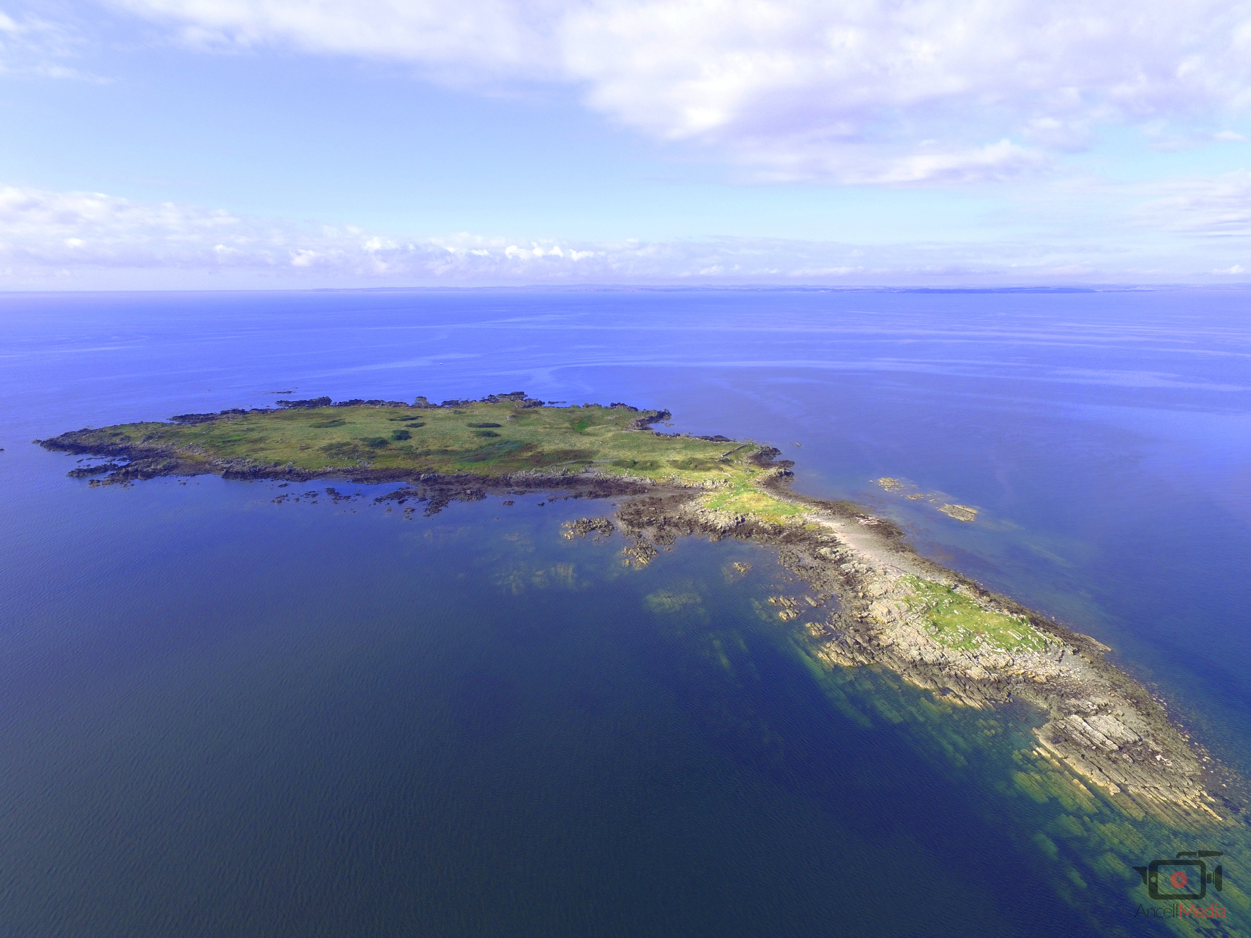 caption: Barlocco Island, located among the Isles of Fleet in Fleet Bay, is for sale. But you may not be able to build your dream home there.