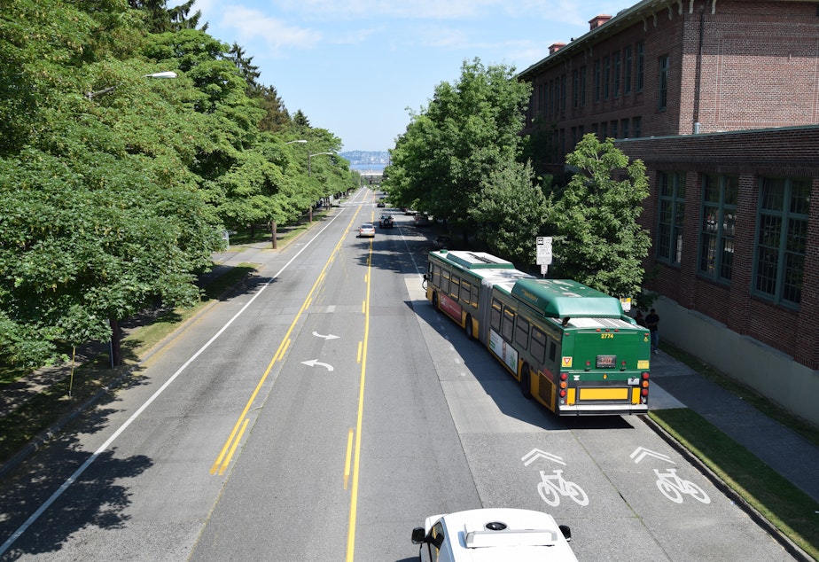 caption: A bus moves into traffic on Delridge Way in West Seattle.
