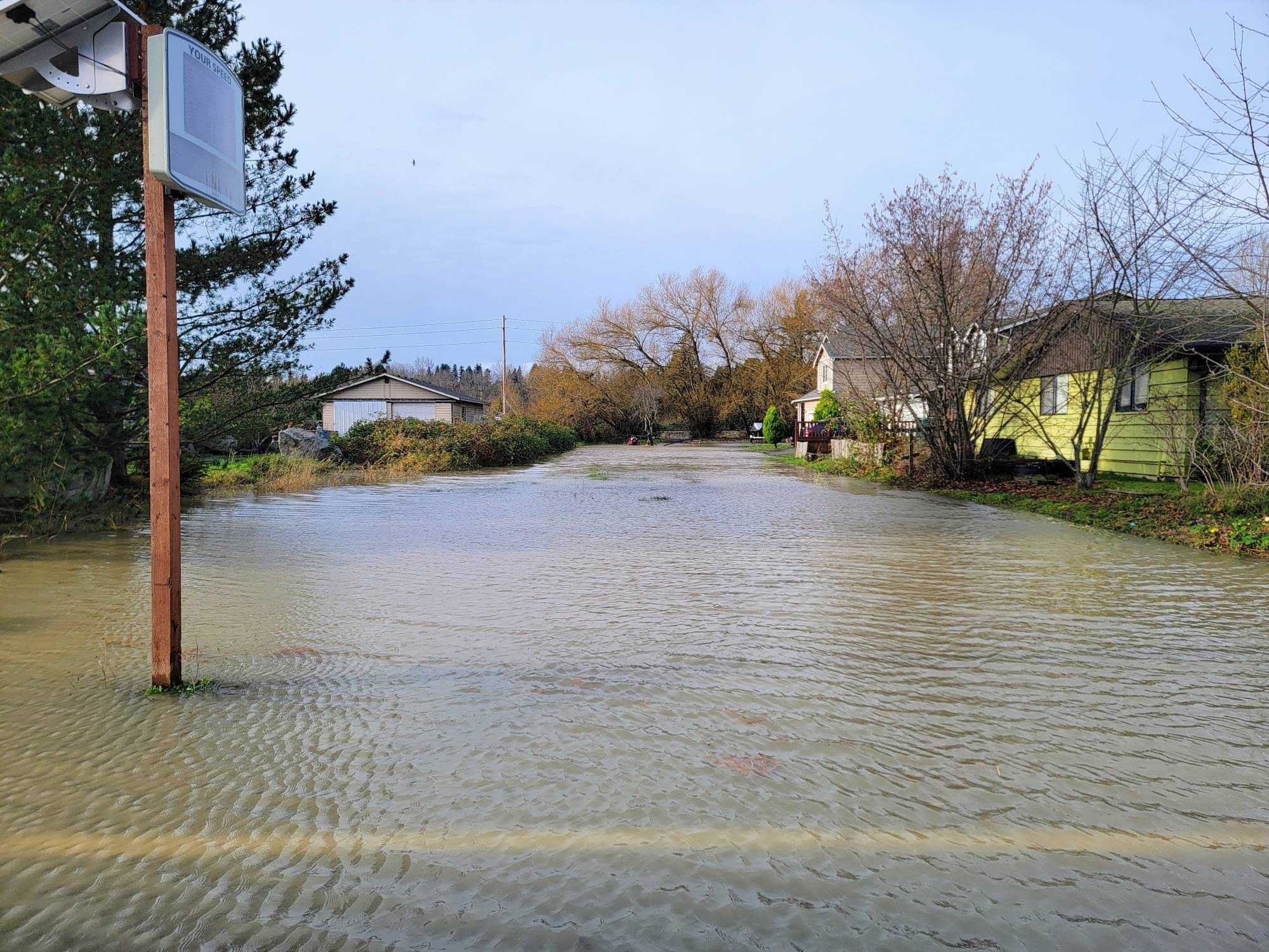 caption: Flooding from the White River levee triggered a Level 3 "GO NOW" evacuation advisory Dec. 16, 2025, in Pacific, Washington.