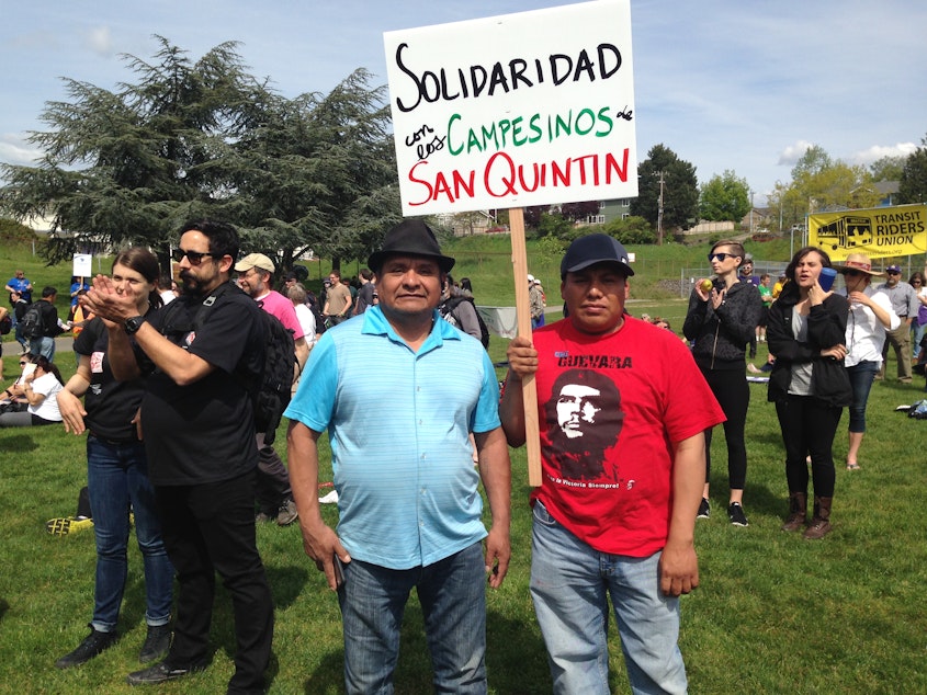 caption: Fidencio Racine (in red) and Salvador Cruz came down from Mount Vernon to attend the immigration rally at Judkins Park on Friday, May 1, 2015.