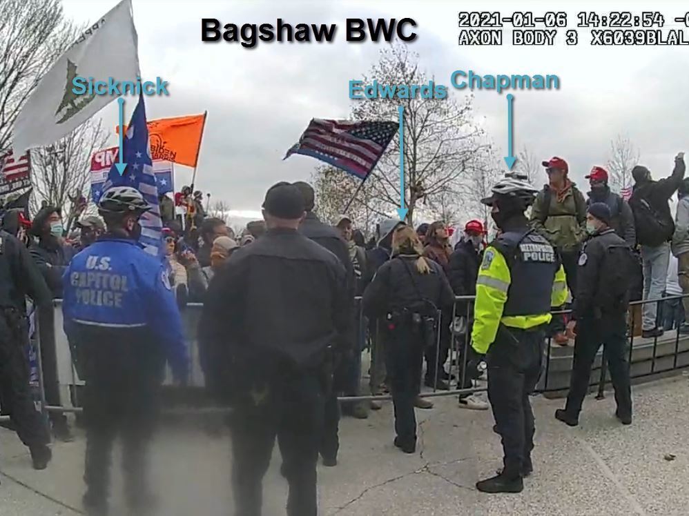 caption: This image from a video released by the Justice Department shows Capitol Police officers, including Brian Sicknick, attempting to hold back a crowd that ultimately breached the U.S. Capitol on Jan. 6.