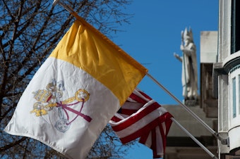 caption: The U.S. flag and flag of Vatican City are hung on the outside of the Pennsylvania Catholic Conference building in Harrisburg, Pa., on March 26, 2019. Catholics outnumber Evangelicals in Pennsylvania by a 2-to-1 margin.