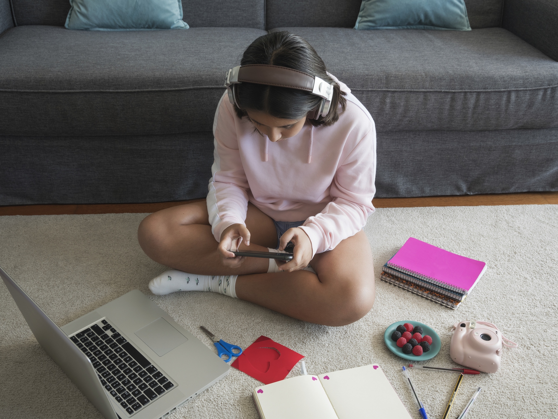 young girl studying and listening to music on the laptop