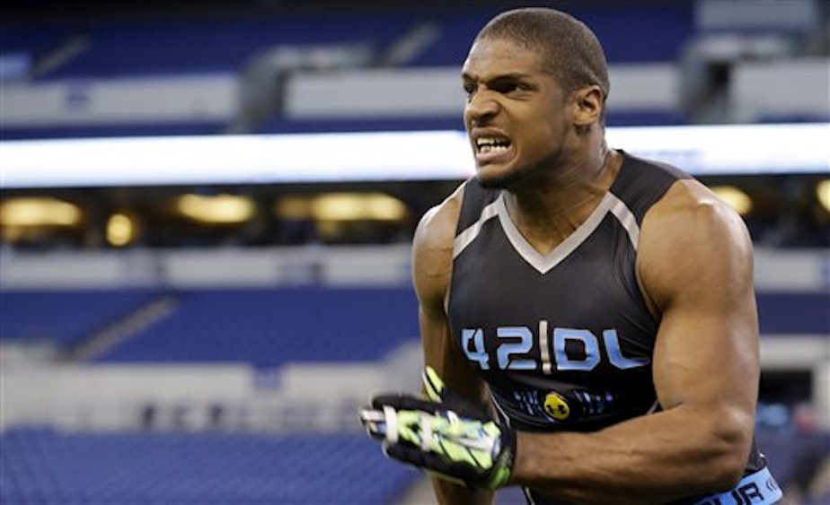 caption: Michael Sam runs a drill at the NFL football scouting combine in February.  He was drafted to the St. Louis Rams last weekend.