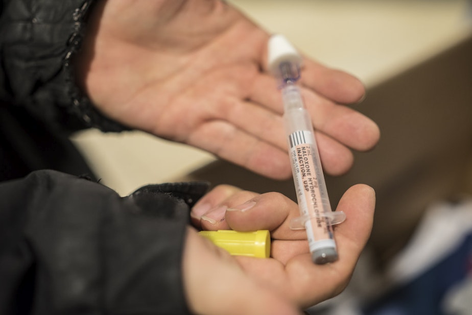 caption: Naloxone syringe is used to combat opioid overdose.