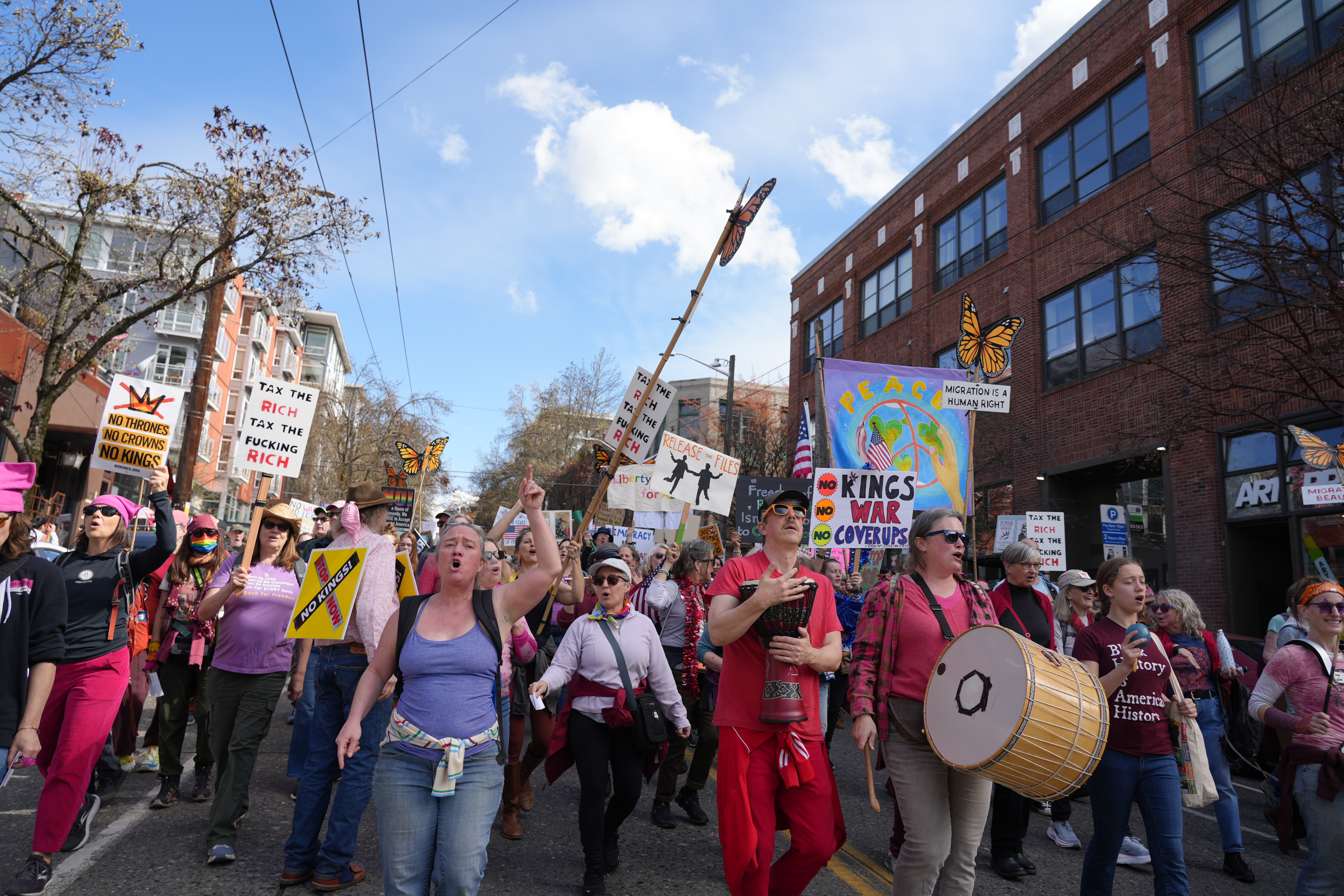 caption: Singing Resistance Seattle members demonstrate at the No Kings protest on March 28, 2026.