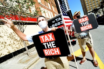 caption: Two protesters from progressive group MoveON calling for higher taxes for the rich and corporations in Tampa, Fl., on May 17. Polls typically show support for increasing taxes for the wealthy.
