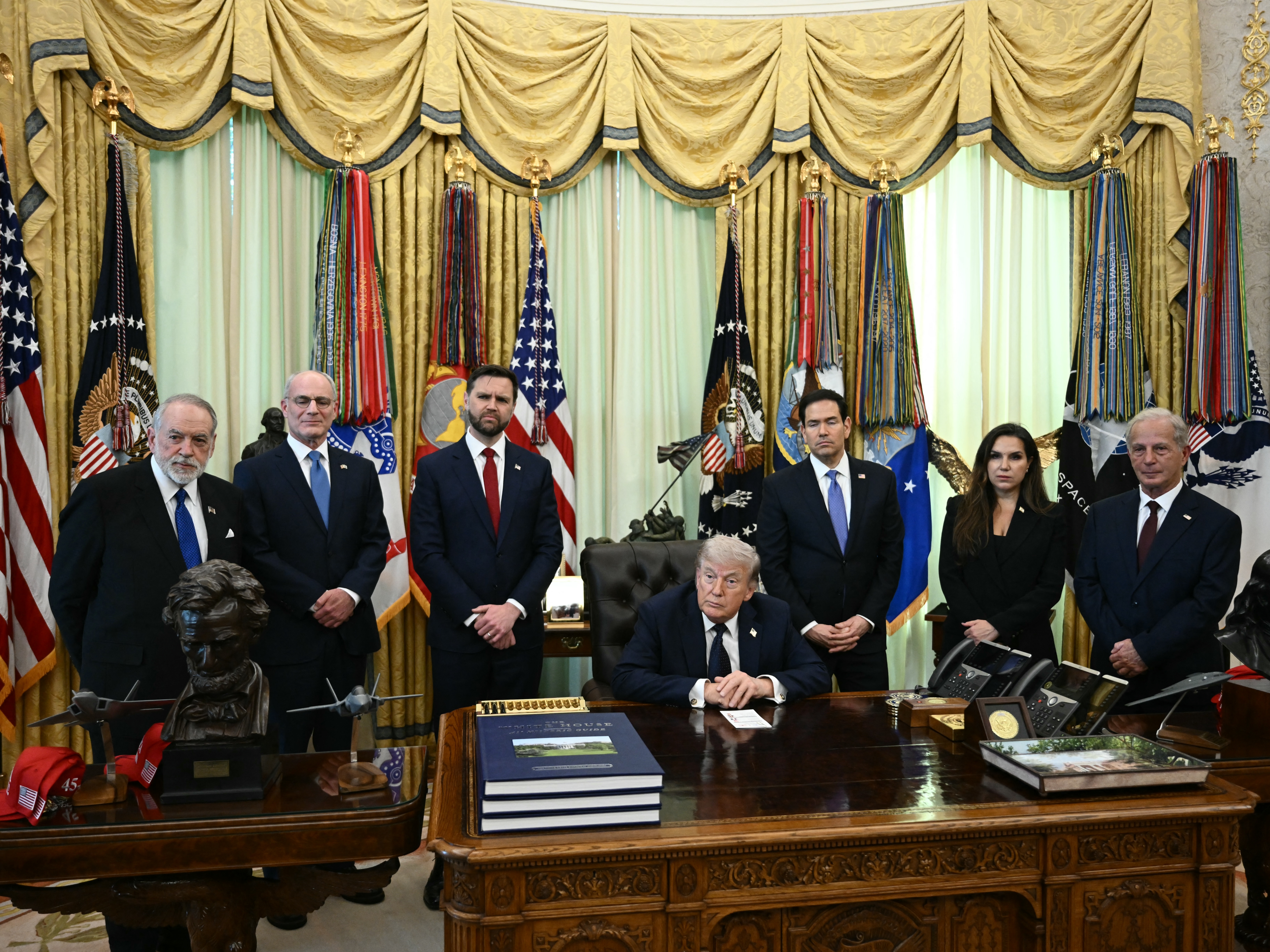 caption: From left: U.S. Ambassador to Israel Mike Huckabee, Israeli Ambassador to the U.S. Yechiel Leiter, Vice President Vance, President Trump, Secretary of State Marco Rubio, Lebanese Ambassador to the U.S. Nada Hamadeh Moawad and U.S. Ambassador to Lebanon Michel Issa listen to questions from the media at the White House in Washington, D.C., on Thursday.