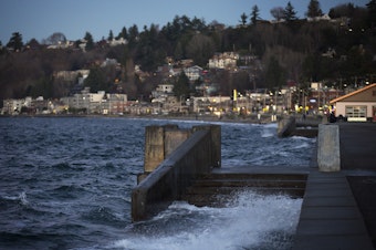 caption: Water spills over a set of stairs that typically lead to the beach during a King Tide at Alki Beach Park on Tuesday, Dec. 5, 2017, in West Seattle. 
