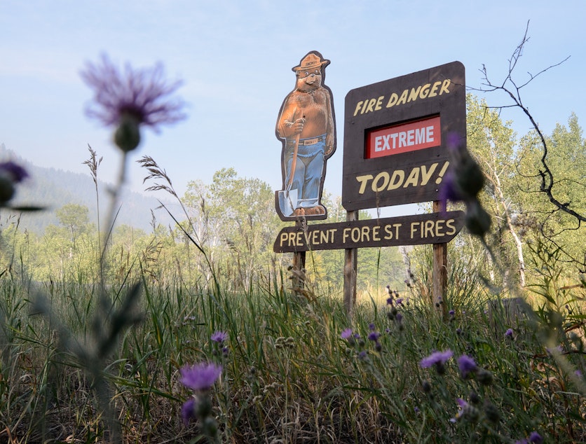 caption: A roadside sign warns of fire danger during the Beaver Creek Fire in Idaho in 2013. 