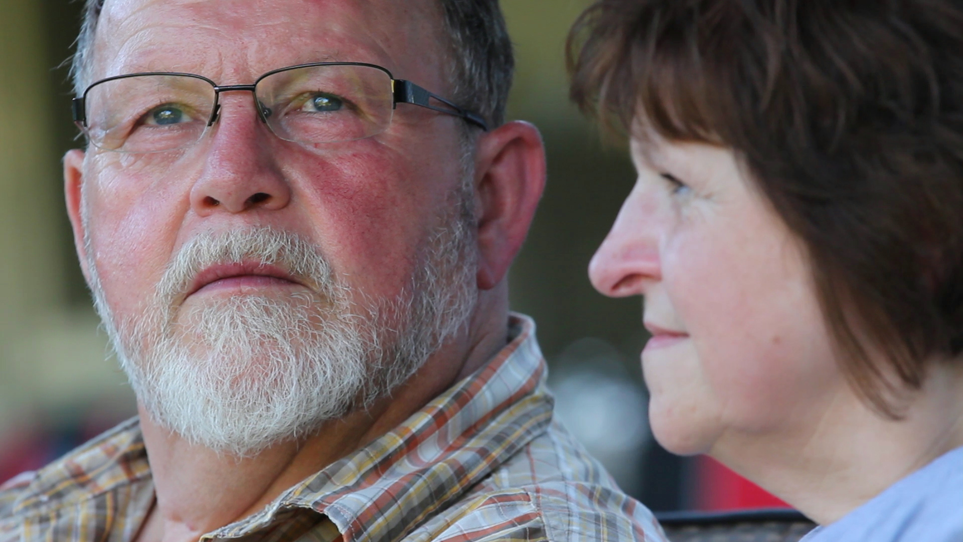 caption: Ron and Gail Thompson outside their new home in the Oso area.