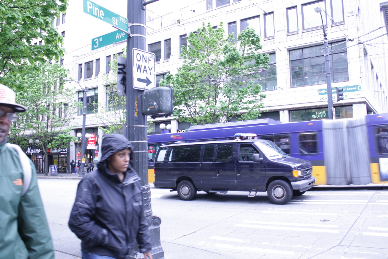 caption: A police van at Third Avenue and Pine Street in downtown Seattle.
