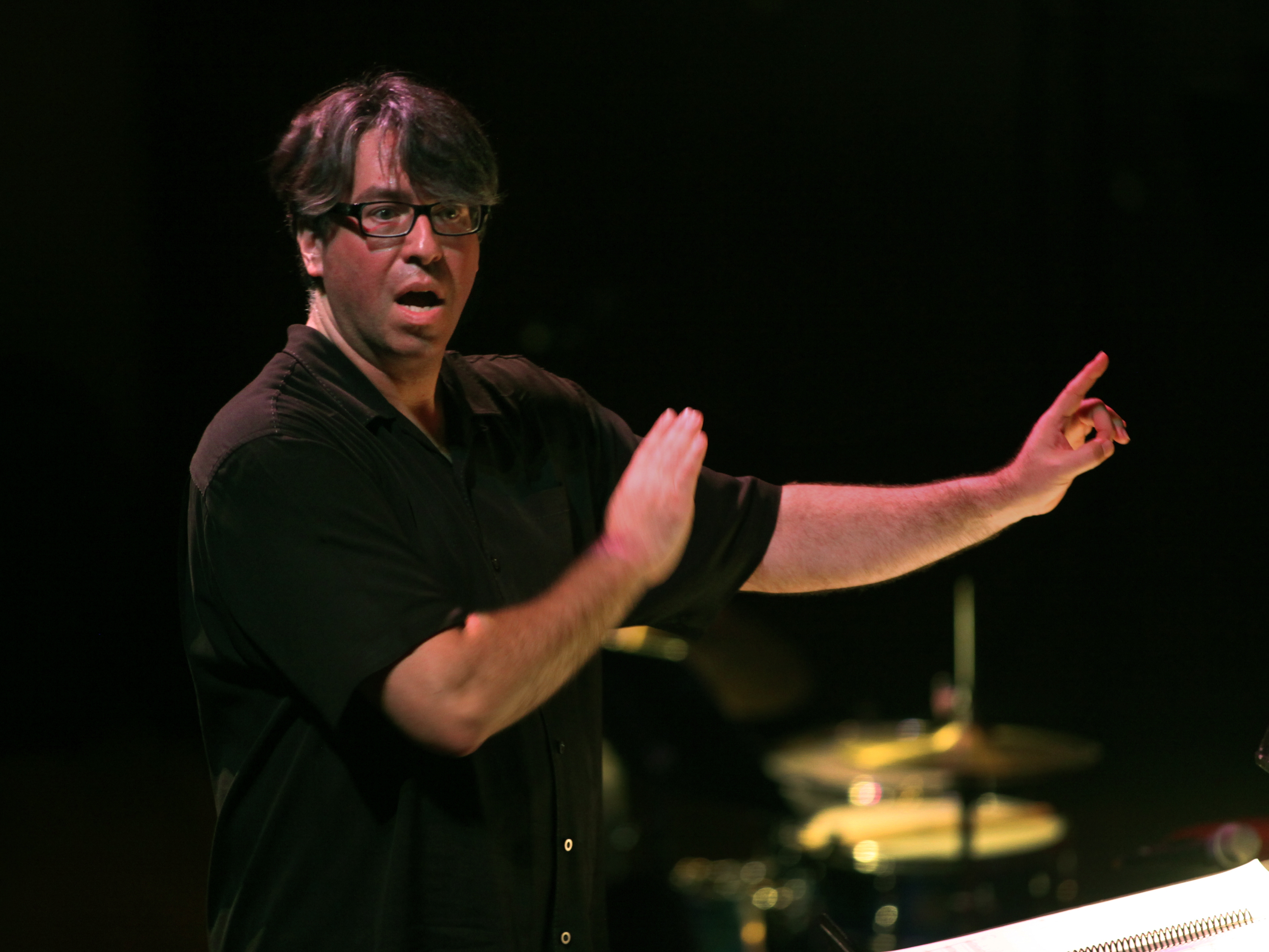 caption: Julian Wachner conducts the choir of Trinity Wall Street and the Bang on a Can All-Stars at Lincoln Center in New York in 2014. Wachner, who was dismissed from his position at Trinity in 2022, has been charged with possession of child sex abuse material in Indiana.