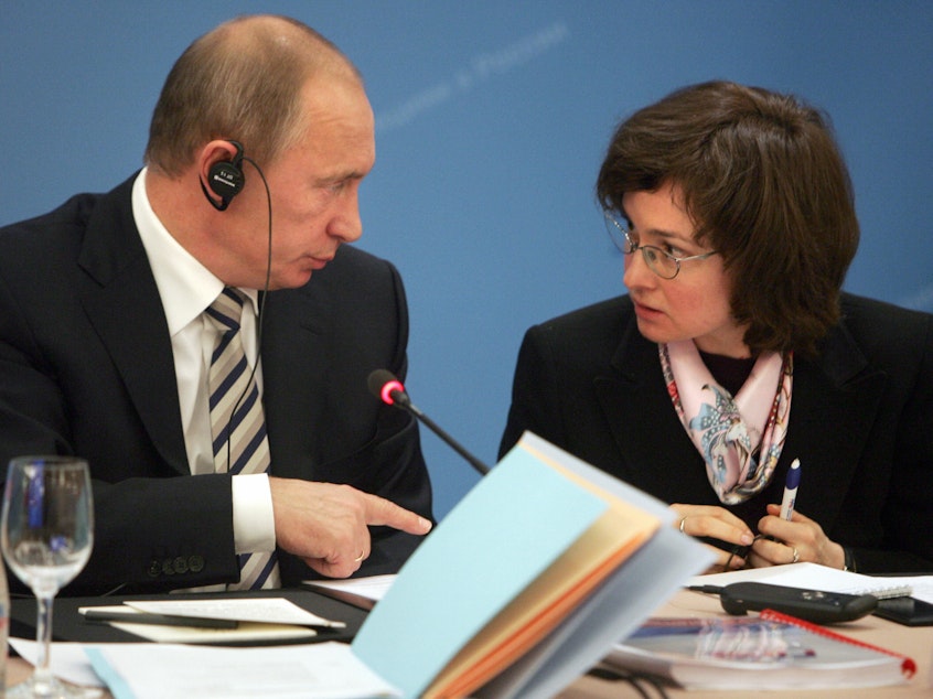 Vladimir Putin speaks with then-economic development and trade minister Elvira Nabiullina in Moscow on October 20, 2008 at a foreign investors advisory council meeting.