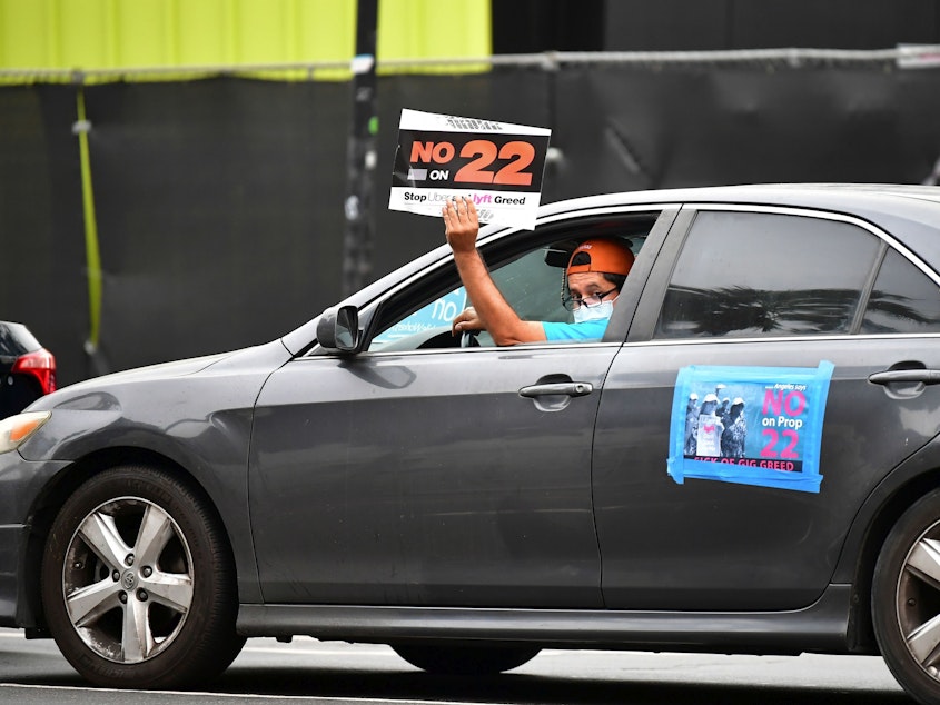caption: A California ballot measure over whether Uber and Lyft should treat their drivers as employees divided gig workers, but was approved by voters.