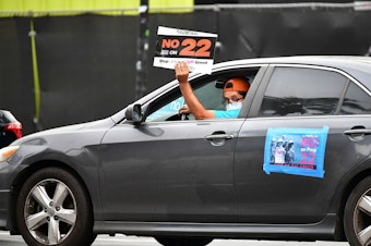 caption: A California ballot measure over whether Uber and Lyft should treat their drivers as employees divided gig workers, but was approved by voters.