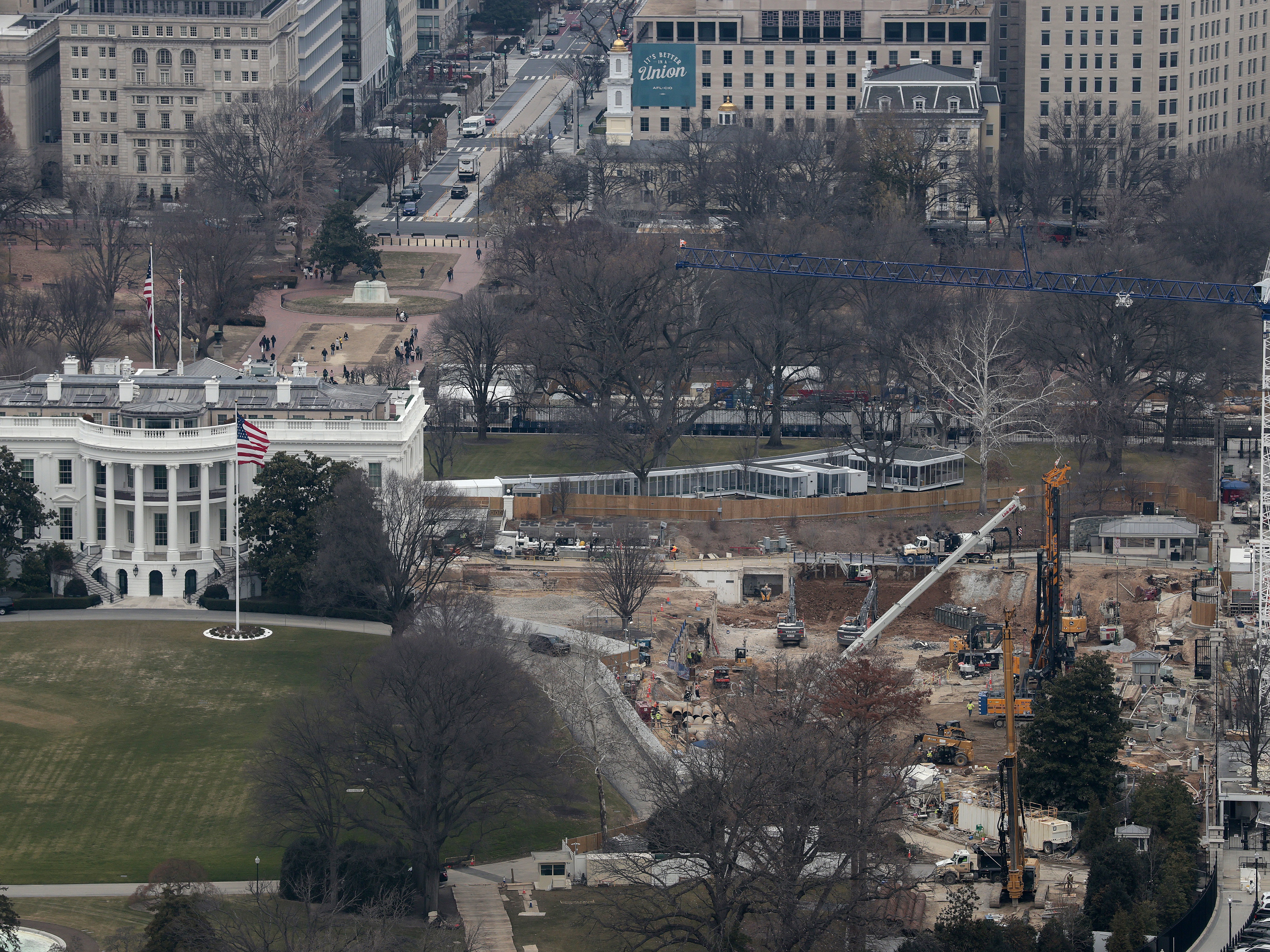caption: Viewed from the observation level of the Washington Monument, demolition work continues where the East Wing once stood at the White House on January 05, 2026 in Washington, D.C.