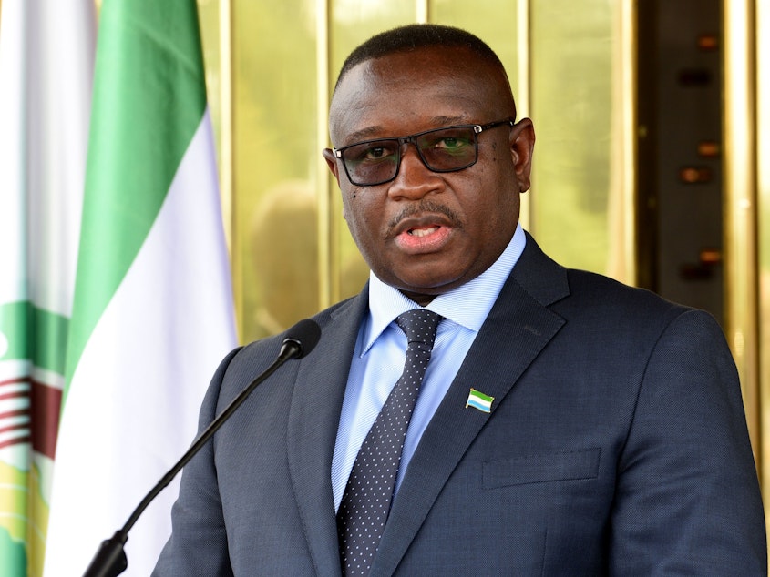 caption: Sierra Leone President Julius Maada Bio, pictured here at a press conference in May 2018, last week declared rape and sexual violence a national emergency.